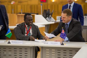 Two corporate businessmen shake hands on a deal