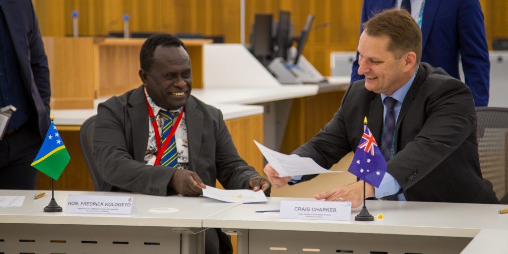 Two corporate businessmen shake hands on a deal